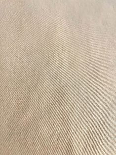 a close up view of a beige fabric