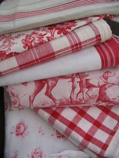 four red and white towels stacked on top of each other in the shape of horses