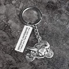 a motorcycle keychain with a metal tag attached to it's front end