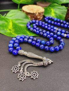 ✔️ This listing is for 1 pc 925k Sterling Silver Lapis Lazuli Tasbih  ✔️ This 925k luxury rosary made by using 5A Grade Lapis lazuli gemstone beads. ✔️ Top quality 925k Sterling Silver Lapis Lazuli Tasbih  ✔️ All the metal parts are 925k Sterling Silver.  ✔️ Beads count: 99 beads  ✔️ Beads size: 6 mm ✔️ Beads cut: Round cut  ✔️ Natural color, no dye, 5A Grade original lapis lazuli gemstone.  ✔️ This elegant tasbih is a very special gift for your loved ones. ✔️ PLEASE CLICK THE LINK FOR ALL PRAYE Luxury Gemstone Beads As Gift, Blue Gemstone Beads Rosary For Spiritual Use, Spiritual Polished Lapis Lazuli Beads, Blue Spiritual Rosary With Gemstone Beads, Spiritual Blue Rosary With Gemstone Beads, Blue Gemstone Beads For Gifts, Traditional Blue Jewelry With 8mm Beads, Traditional Blue Beads With Natural Stones, Traditional Blue Polished Beads, Gems, And Cabochons