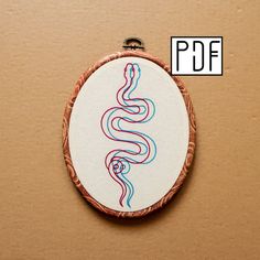 an embroidery pattern is shown in the shape of a snake