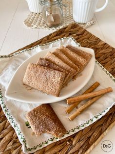 there is a plate with some bread and cinnamon sticks on it