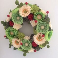 a wreath made out of felt flowers and leaves