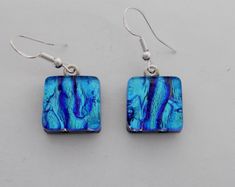 two square shaped blue earrings with silver hooks