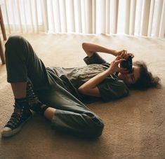 a person laying on the floor with a camera