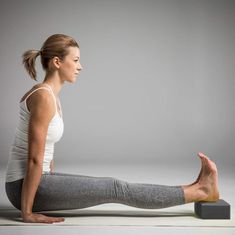 a woman is sitting on the floor with her legs crossed