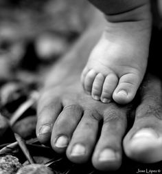 a black and white photo of a baby's feet