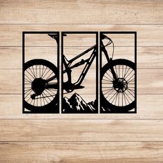 the silhouette of a mountain bike is shown on a wooden wall with wood planks