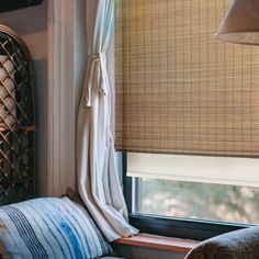 a window seat with a blue and white striped pillow on it