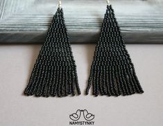 These black beaded earrings are made of high-quality Czech beads and strong synthetic thread. They are elegant, fashionable, and highly versatile, suitable for everyday wear. Features: Sterling silver components Color: white Length (approximate): 9 cm (3.5 in) This item is currently in stock. More beaded earrings http://etsy.me/2ycItdb Gerdan necklaces http://etsy.me/2mihf0J Beaded necklaces http://etsy.me/2Dkf1Fo Crochet necklaces http://etsy.me/2CAPdFc Back to shop https://www.etsy.com/shop/Na Elegant Black Earrings With Tiny Beads, Black Beaded Fringe Earrings As Gift, Black Beaded Drop Earrings, Elegant Black Beaded Earrings With Tiny Beads, Elegant Black Beaded Drop Earrings, Black Beaded Fringe Earrings With Round Beads, Black Beaded Earrings With Round Beads And Fringe, Elegant Black Dangle Beaded Earrings, Black Beaded Fringe Earrings For Party