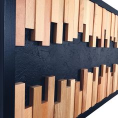 a black wall with wooden blocks on it