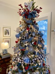 a christmas tree decorated with blue and white ornaments