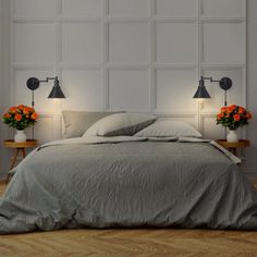 a bed with two lamps on either side of it