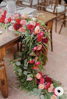 the table is set with flowers and candles