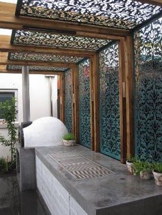 an instagram photo of a patio covered in decorative iron screens and potted plants