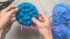 someone is crocheting a blue ball of yarn