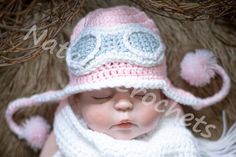 a newborn baby wearing a pink and white crocheted hat