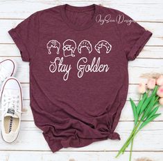 "DESCRIPTION Golden Girls Shirt, Stay Golden, Golden Girls Name Shirt , 80's TV Sitcom , Rose, Blanche, Dorothy, Sophia, Golden Years, Golden Girls Fan HOW TO ORDER 1. Select the shirt \"Style and Size\" 2.Select the shirt Color 3. Enter what would you like to say on your t shirt and LETTERING color 4.Select the quantity. 5. Click Add to cart. If you have any difficulties, send us a message. Processing Time and Shipping The standard processing time is 1-3 business days. We usually proses and shi Golden Girls Shirt, Cheer Camp, Camper Shirt, Country Music Shirts, Rose Shirts, Vintage Band Tees, Stay Golden, Camp Life, Golden Years