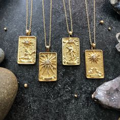 Gorgeously detailed tarot card pendants dangle from 14k gold filled cable chain with a lobster clasp closure. Choose your Astrological Adventure: The Star, The Sun, The World or The Moon. These pendants are 18K gold filled and measure 30 x 15 mm in size. The Star/Meaning When the Star card appears, you are likely to find yourself feeling inspired. It brings renewed hope and faith and a sense that you are truly blessed by the universe at this time. The Sun/Meaning: The card portends good fortune, Celestial Gold Jewelry With Rectangular Pendant, Gold Celestial Jewelry With Rectangular Pendant, Mystical Gold Charm Necklace Gift, Star Meaning, Spike Hoop Earrings, Gold Charm Necklace, Gold Pendant Necklace, Gold Charm, Gold Filled Jewelry