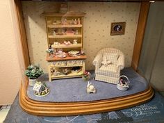 a doll house with furniture and accessories on display