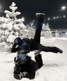 a snowboarder is falling off his board in the snow