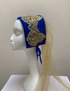 New adult women's Renaissance Medieval Tudor Elizabethan queen royalty blue velvet beaded look hat cap costume. Ornate gold beaded design look headband with flowing gold sheer back veil. Gold beads to adorn the crown. Ribbon back tie to hold in place. 16 1/2" by 5" crown and 23" length veil. Sales final. Great for your next theme party, stage production or special event. Tudor Bonnet Hat, Adjustable Gold Costume Headpieces, Adjustable Gold Headpiece For Costume, Gold Headband For Costume, Traditional Fitted Costume Hats And Headpieces, Gold Costume Hats With Round Crown, Traditional Fitted Headpiece For Costume, Gold Tall Crown Costume Hats And Headpieces, Fitted Gold Costume Hat For Carnival