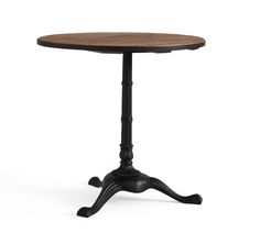 an old fashioned wooden table with black metal legs and a round top, on a white background