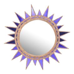 a blue and gold sunburst mirror on a white background