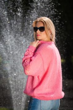 "Pink Mohair blend sweater. Summer top - loose and soft, made by a soft mohair blend yarn. V neck with ties. Lace pattern on sleeves Non itchy . This gorgeous sweater is a great choice for your summer walks, along the beach or in the nature. Its the perfect choice for your city style as well! Fits S and M sizes best Oversized style. 100 % hand knitted Mesurements: Body lenght: 24 \" / 60 cm Chest width: 25\" / 62 cm All measurments are taken with the item flat and not streched. Please check care Pink Open Knit Winter Sweater, Pink Open Knit Sweater For Winter, Pink Mohair Sweater For Winter, Winter Pink Open Knit Sweater, Cozy Pink Mohair Sweater, Pink Mohair Sweater For Fall, Pink Mohair Knitted Cardigan, Pink Mohair Sweater For Spring, Oversized Hand-knitted Pink Sweater