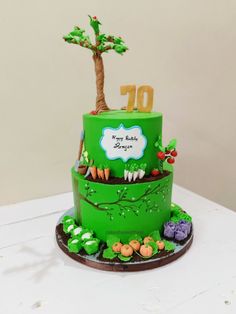 a green birthday cake with trees and flowers on the bottom tier, decorated with an age ten sign