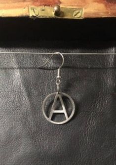 Anarchy, small - earring Stainless steel, 2cm wide and 2mm thick Single Round Metal Cartilage Earring, Symbolic Round Metal Hoop Earrings, Pierced Round Stainless Steel Earrings, Metal Symbolic Hypoallergenic Earrings, Round Stainless Steel Cartilage Earrings, Hypoallergenic Metal Cartilage Earrings, Symbolic Nickel-free Hoop Earrings, Symbolic Metal Hoop Earrings As Gift, Nickel-free Metal Plug Earrings