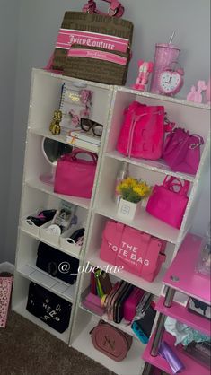 a white shelf filled with lots of pink purses and handbags on top of it