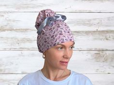 a woman wearing a head wrap with an animal print pattern on the top and side