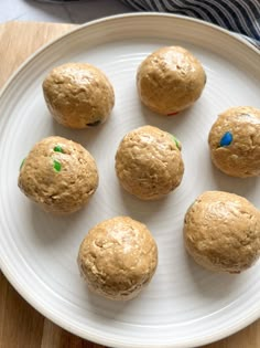 a white plate topped with muffins on top of a wooden table