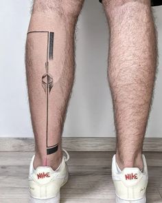 a man's legs with tattoos on them and the words nike painted on it