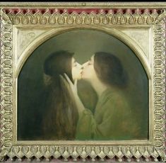 two women kissing each other in front of a painting with gold trim around the edges