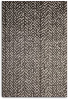 an area rug with grey and white herringbones