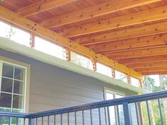 a porch covered in wood and metal railings