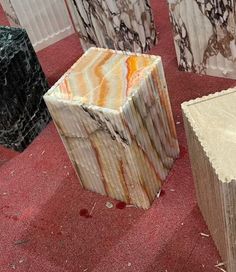 marble blocks sitting on the floor in an area that looks like it has red carpet