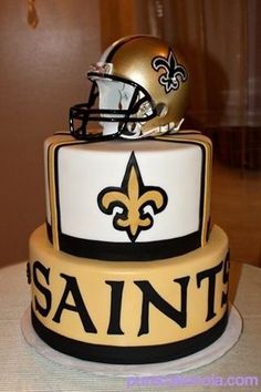 a new orleans saints cake with a helmet on top