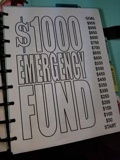 a book with the words $ 1, 000 emergency fund written on it