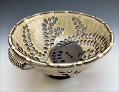 a decorative bowl with holes in the middle