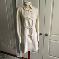 Beautiful Coat From J. Crew. Cream White Color, With Four Ornate Knot And Loop Closure. Size 6. Near Collar, Has A Hidden Button Closure, With Two Silver Hook Closure For A Closed Up Look. One Open Hand Pockets On Each Side, With Felt Like Soft Material Inside. Back Vent Flap. Interior Cream Satin Material Lining With Pink Piping With White Diagonal Stripe. Interior Left Chest Had Open Pocket With Button Closure. Elegant, Classic, Quality Coat From J. Crew That I Remember Wearing Once To A Wedding And Doubt I Will Ever Wear Again. Miraculously No Stains Or Imperfections Found Or Visible, Just Very Slight Discoloration In Neck Collar Area (Had To Hold To The Light To See). 80% Wool, 20% Nylon Chic Cream Pea Coat With Button Closure, White Sweater Coat With Button Closure, White Wool Outerwear With Buttons, Cream Wool Coat With Button Closure, Timeless Long-sleeved Pea Coat With Double Button Closure, Blair Waldorf Aesthetic, White Wool Coat, Cream White Color, Open Hands