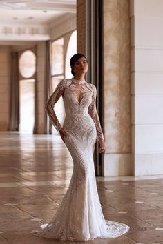 a woman in a long sleeved wedding dress