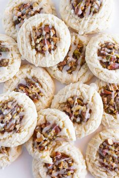 a white plate topped with cookies covered in frosting and toppings on top of each other