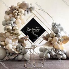 balloon arch with gold, silver and white balloons in the shape of wreaths on display