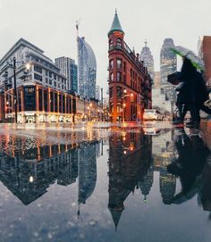 a person with an umbrella is walking in the rain