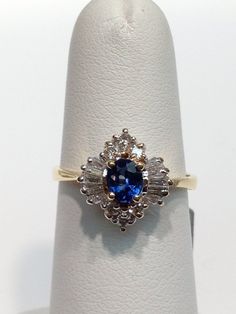 Vintage Sapphire and Diamond Ring Set in 14K White Gold and Yellow Gold. Brilliant Cut and Baguette Cut Diamonds set around an Oval Shaped Sapphire. Diamonds are approximately G-Color, VS Clarity. The Sapphires are Gem Quality, Velvety Saturated Blue, Clarity is very good in the sapphires. Diamonds are at a half carat total weight, sapphire is approximately 1 carat. Please specify the size you would like so that I can have it made to fit for you. Classic Oval Multi-stone Cluster Ring, Classic Oval Cluster Ring With Multi-stone, Oval Multi-stone Diamond Ring In 14k Gold, Oval Multi-stone 14k Gold Diamond Ring, Oval 14k Gold Multi-stone Diamond Ring, Oval Sapphire Ring In Stamped 14k White Gold, Oval Diamond Ring Stamped 14k Fine Jewelry, Stamped 14k Oval Diamond Ring Fine Jewelry, Exquisite Oval Cluster Ring With Diamond Cut