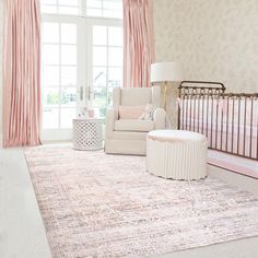 a baby's room with pink and white decor