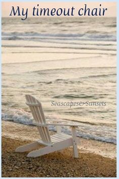 a white lawn chair sitting on top of a sandy beach next to the ocean with waves coming in